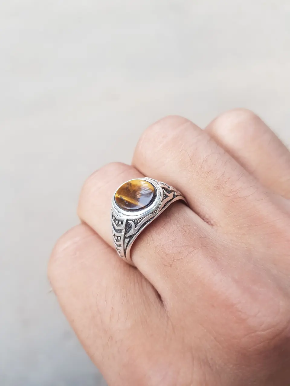 A sterling silver gemstone ring on a hand