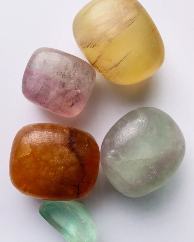 A set of pastel tumbled stones in yellow, purple, green and orange