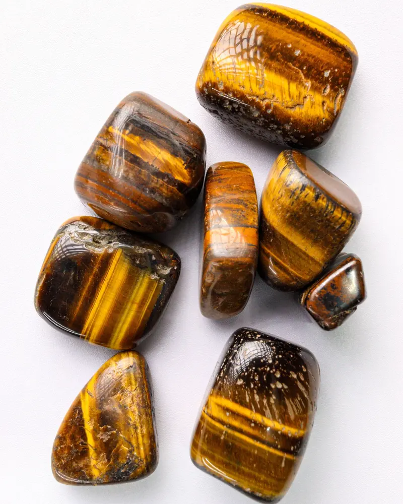 Polished tumbled tiger's eye stones with golden bands
